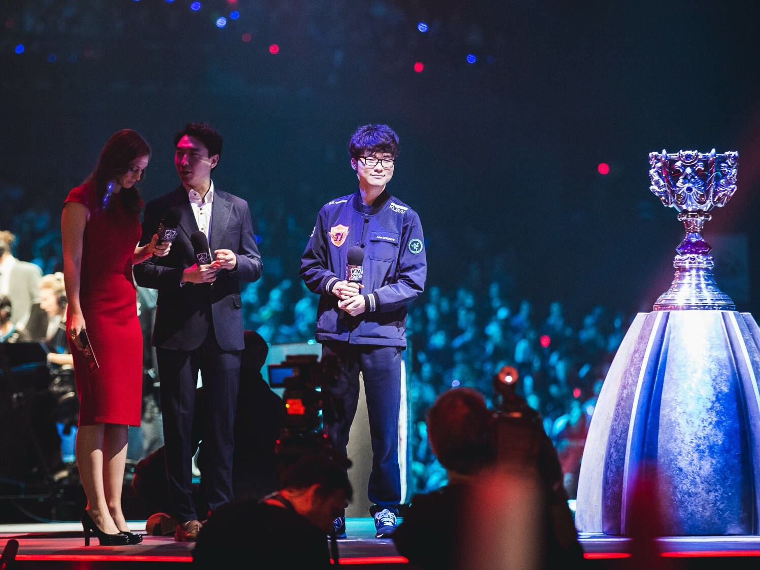 Faker on stage beside the Summoner's Cup at the 2015 World Championship