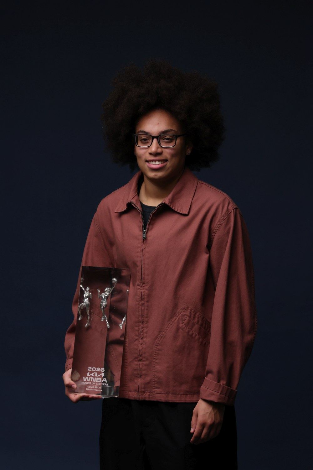 Olivia Miles holding the 2026 WNBA Rookie of the Year trophy