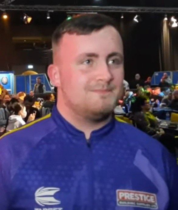 A 15-year-old Luke Littler at a darts event